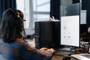 An IT support agent working at their computer.