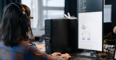 An IT support agent working at their computer.