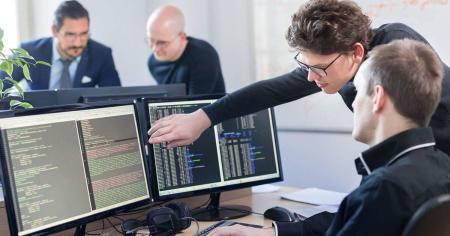 Two developers reading code via Splashtop remote access software