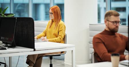 Workers in an office on their computers.