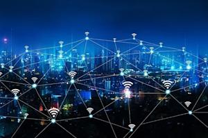 A city skyline at night with glowing lines and Wi-Fi symbols connecting buildings, representing a networked or smart city with widespread wireless internet connectivity.