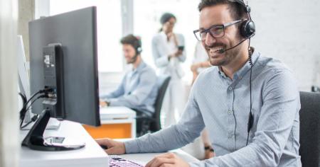 IT helpdesk specialist talking to a client with headset on 