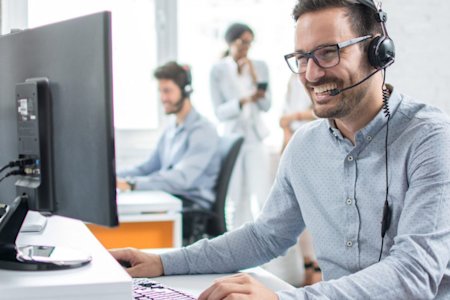 IT helpdesk specialist talking to a client with headset on