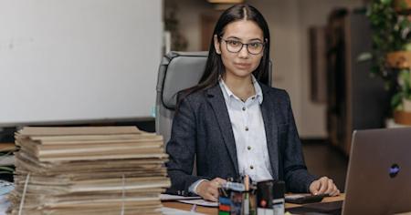 A person in an office working on a computer.