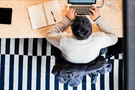 IT admin at desk using laptop for remote computer access