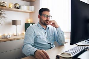 IT technician at computer researching remote software options for secure access
