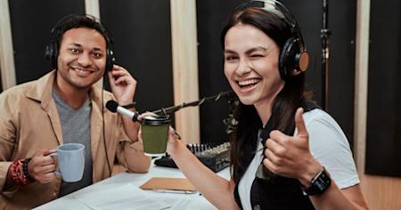 Two individuals with headphones on giving a thumbs up in approval of Splashtop's software on a podcast