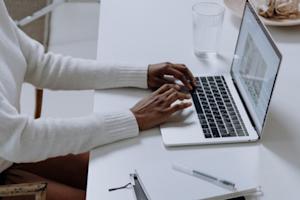 Person using a laptop and researching Splashtop Business Access, listed among top 5 remote desktop features online