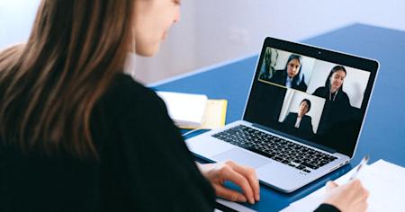 A businesswoman in a video call with her co-workers.