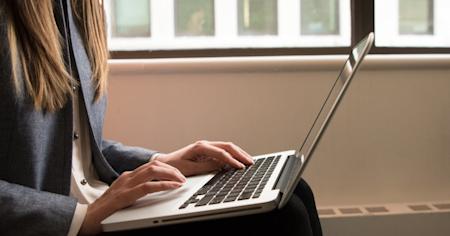 A person using a laptop computer.