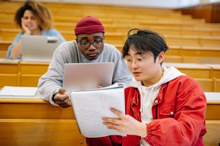 Two university students studying in a classroom