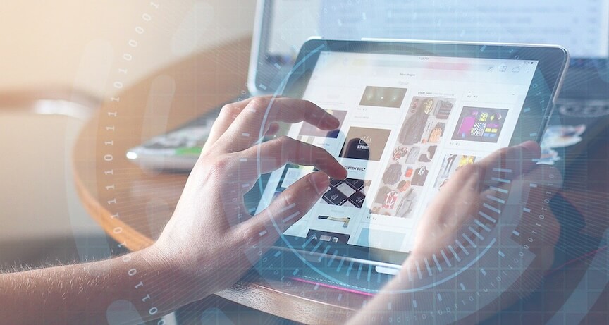 A person uses a tablet with both hands, browsing through images or products. A laptop is visible in the background, and a light, futuristic digital overlay surrounds the scene.