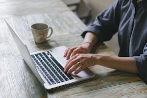 A person typing on a laptop.