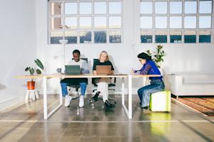 Three employees of a small business using Splashtop's remote IT support features.