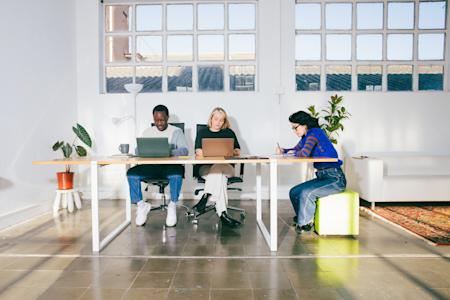 Three employees of a small business using Splashtop's remote IT support features.