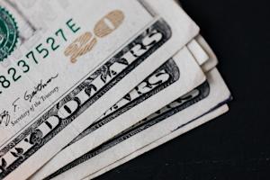 A pile of money, showing that Splashtop Remote Support costs much less when compared to LogMeIn Central pricing