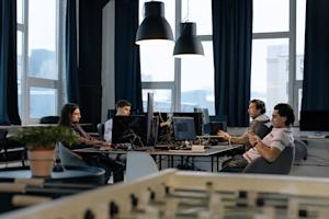 A group of people working on computers in an office.