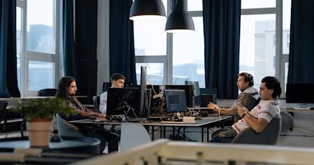 A group of people working on computers in an office.