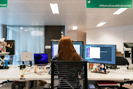 A woman at work in an office using a desktop computer.
