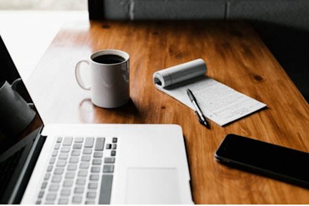 Laptop computer on wooden desk connected with Splashtop remote computer access software