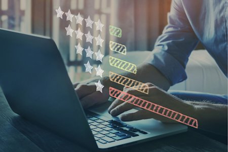 Person using a laptop computer to rate computer software