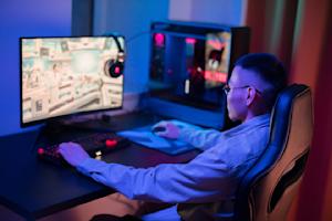 A young man using Splashtop's remote desktop software to play video games remotely.