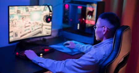 A young man using Splashtop's remote desktop software to play video games remotely.
