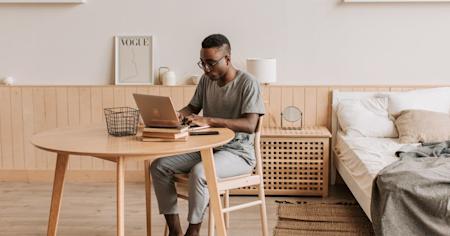 An IT worker working from home on a laptop.