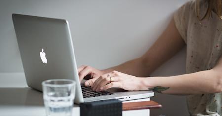 A person using a laptop computer.