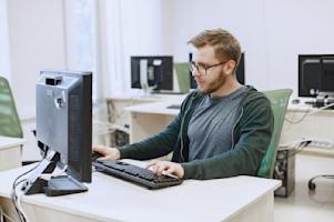 A man working at his computer in an office.