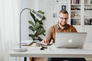 A man working remotely in his home office.