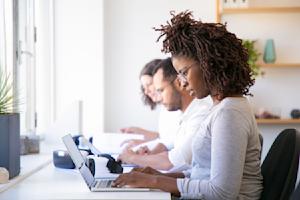 Team collaborating in a shared workspace using multi-user remote desktop access.