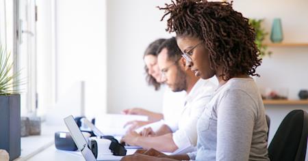 Team collaborating in a shared workspace using multi-user remote desktop access.