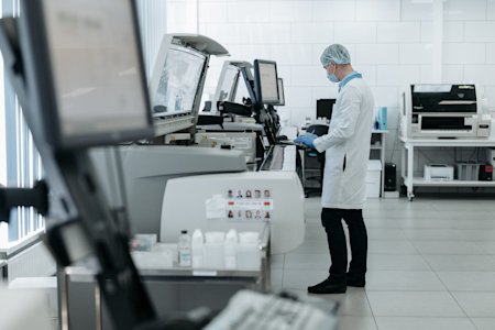 A healthcare professional using a computing machine.