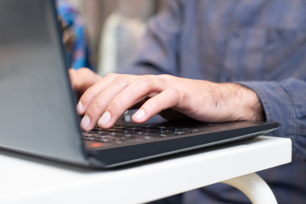 A person typing on a computer.