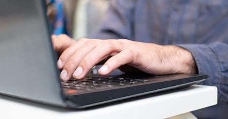 A person typing on a computer.