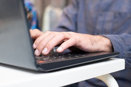 A person typing on a computer.