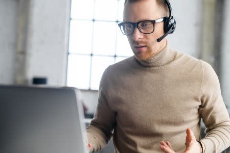 Helpdesk manager providing remote support with a headset