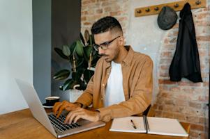 An IT tech working on a laptop.