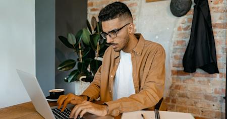 An IT tech working on a laptop.