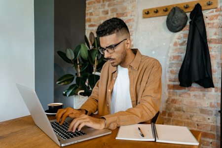 An IT tech working on a laptop.