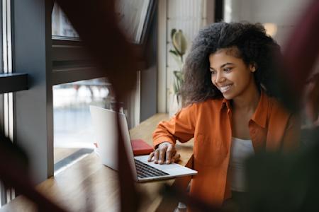 Female IT professional looking at a laptop possibly browsing career opportunities at Splashtop