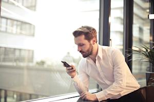 A business man using a smartphone while working.