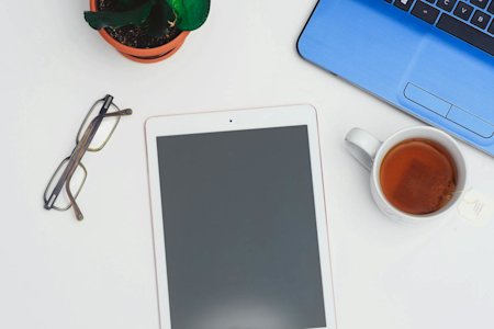 An iPad laying on a desk.