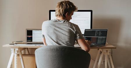 A remote worker at his home computer working digitally.