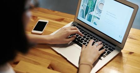 A person using a laptop computer.