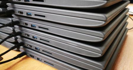 A stack of Chromebook devices.