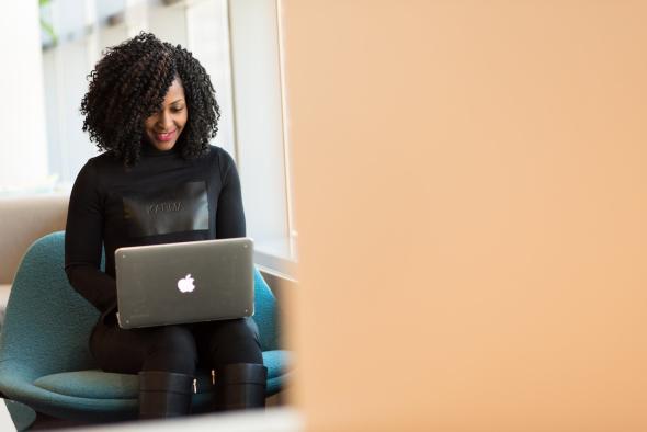 A woman using Splashtop remote desktop software on her MacBook to work on the go.