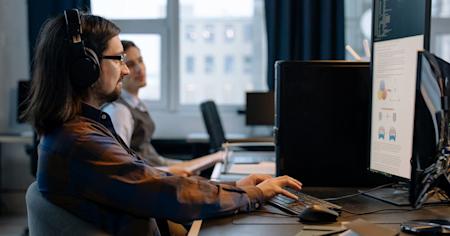Two IT workers on their computers.