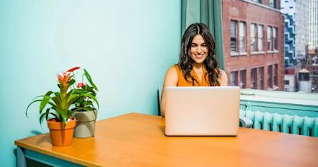 A happy woman using Splashtop on her laptop.